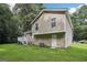 A two-story home features a green lawn and a small deck with stairs in the backyard at 3980 Carlton Cove Ct, Loganville, GA 30052
