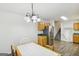 Bright dining area with a white chandelier, table, stainless steel appliances and stairs in view at 3980 Carlton Cove Ct, Loganville, GA 30052