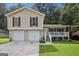 Charming home featuring a two-car garage, front porch, and a well-manicured lawn at 3980 Carlton Cove Ct, Loganville, GA 30052