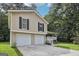 Attractive exterior showcasing a two-story home with a two-car garage and manicured lawn at 3980 Carlton Cove Ct, Loganville, GA 30052