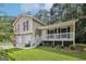 Inviting home with a two-car garage, white porch and lush green lawn and landscaping at 3980 Carlton Cove Ct, Loganville, GA 30052