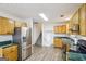 Kitchen featuring stainless steel refrigerator and laminate countertops with stairs in view at 3980 Carlton Cove Ct, Loganville, GA 30052