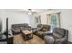 Comfortable living room featuring plush sofas, wood floors, and natural light at 3980 Carlton Cove Ct, Loganville, GA 30052
