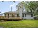 Backyard showcasing large deck, well-maintained lawn, and mature trees at 9591 Teal Ter, Jonesboro, GA 30238