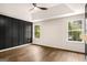 The bedroom has a modern decorative wall, fan, tray ceiling, and two windows at 9591 Teal Ter, Jonesboro, GA 30238
