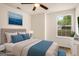 Cozy bedroom with a ceiling fan, ample natural light, and warm hardwood floors at 9591 Teal Ter, Jonesboro, GA 30238
