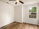 Bedroom with a ceiling fan, hardwood floors, and a bright window view at 9591 Teal Ter, Jonesboro, GA 30238
