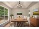 Dining room with wood-look floors, tray ceilings, stylish chandelier, and a picture window at 9591 Teal Ter, Jonesboro, GA 30238