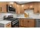 The kitchen features stainless steel appliances, white quartz countertops, and wood-look cabinetry at 9591 Teal Ter, Jonesboro, GA 30238