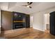 The living room features a modern electric fireplace, fan, tray ceiling, and wood-look flooring at 9591 Teal Ter, Jonesboro, GA 30238
