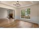 Spacious living room with wood-look floors, fireplace, and a large window overlooking the backyard at 9591 Teal Ter, Jonesboro, GA 30238