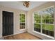 Inviting sunroom with hardwood floors, large windows, and a backyard view at 9591 Teal Ter, Jonesboro, GA 30238