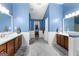 Bathroom features blue walls, white trim, dual sink vanities, and en-suite access at 368 Yellowwood Dr, Sharpsburg, GA 30277