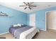 Cozy bedroom with ceiling fan and blue accent wall at 368 Yellowwood Dr, Sharpsburg, GA 30277