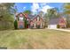 Beautiful two-story home with stone facade, red accents, and a well-manicured lawn at 368 Yellowwood Dr, Sharpsburg, GA 30277