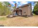Back exterior featuring a brick patio with a pergola, a brown siding and a chimney at 368 Yellowwood Dr, Sharpsburg, GA 30277