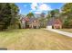 Picturesque home with detached garage on a large lot, surrounded by mature trees and lush greenery at 368 Yellowwood Dr, Sharpsburg, GA 30277