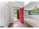 Inviting foyer featuring hardwood floors, a red front door, and a view of the front yard at 368 Yellowwood Dr, Sharpsburg, GA 30277