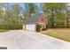 Detached garage with ample parking space and additional storage, surrounded by trees at 368 Yellowwood Dr, Sharpsburg, GA 30277