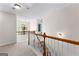 Second floor hallway with railing that overlooks a round window at 368 Yellowwood Dr, Sharpsburg, GA 30277