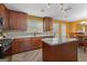 Bright kitchen featuring a kitchen island, granite countertops, wooden cabinets, and stainless steel appliances at 368 Yellowwood Dr, Sharpsburg, GA 30277