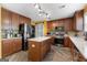 Lovely kitchen with wood cabinets, stainless steel appliances, kitchen island and an adjacent sliding barn door at 368 Yellowwood Dr, Sharpsburg, GA 30277