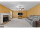 Spacious living room featuring a stone fireplace, a ceiling fan and comfortable seating at 368 Yellowwood Dr, Sharpsburg, GA 30277
