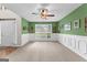 Spacious living room with carpeted floors, decorative wainscoting, and a ceiling fan at 368 Yellowwood Dr, Sharpsburg, GA 30277