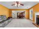 Open-concept living area shows a fireplace, dining space and kitchen in a cozy and inviting layout at 368 Yellowwood Dr, Sharpsburg, GA 30277
