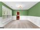 Bright, open living room featuring wainscoting, neutral carpet, and a large window at 368 Yellowwood Dr, Sharpsburg, GA 30277