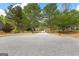 View of the home from the street, showcasing the long driveway and mature trees at 368 Yellowwood Dr, Sharpsburg, GA 30277