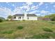 A bright, sunny backyard view with fresh green grass and fencing at 1416 Flanagan Mill Dr, Auburn, GA 30011