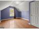 Upstairs bedroom features hardwood floors, a dormer window, and a closet with panel doors at 1416 Flanagan Mill Dr, Auburn, GA 30011