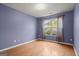 Bright bedroom features hardwood floors, large window with natural light, and neutral paint at 1416 Flanagan Mill Dr, Auburn, GA 30011