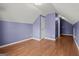 Upstairs bedroom features hardwood floors, closet with panel doors, and sloped ceilings at 1416 Flanagan Mill Dr, Auburn, GA 30011