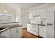 Bright kitchen featuring granite countertops, white cabinets, and stainless steel appliances at 1416 Flanagan Mill Dr, Auburn, GA 30011
