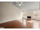 Sun-filled living room featuring hardwood floors, a fireplace, and abundant natural light at 1416 Flanagan Mill Dr, Auburn, GA 30011
