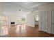 Open-concept living room with hardwood floors, a fireplace, and a ceiling fan at 1416 Flanagan Mill Dr, Auburn, GA 30011