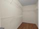 Walk-in closet featuring wire shelving and wood flooring for ample storage space at 1416 Flanagan Mill Dr, Auburn, GA 30011