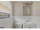 This bathroom features a window, toilet, and sink with vanity at 6064 Oak Hill Dr, Austell, GA 30168