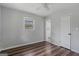 This bright bedroom features a ceiling fan, wood floors, and an adjacent bathroom at 6064 Oak Hill Dr, Austell, GA 30168