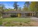 Charming brick ranch-style home with a yellow door, covered porch, and well-maintained landscaping at 6064 Oak Hill Dr, Austell, GA 30168