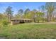 Charming ranch-style home with a sprawling green lawn and mature trees at 6064 Oak Hill Dr, Austell, GA 30168