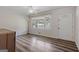 A well-lit living room features a front door, window with blinds, and updated floor at 6064 Oak Hill Dr, Austell, GA 30168