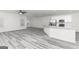 Open-concept living room and kitchen features hardwood floors and lots of natural light at 3363 Arabian Farm Ln, Dacula, GA 30019