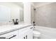 Clean bathroom with gray tile shower, white vanity, and black hardware at 3372 Arabian Farm Ln, Dacula, GA 30019