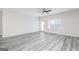 Bright, open living room featuring gray vinyl floors and a ceiling fan at 3372 Arabian Farm Ln, Dacula, GA 30019