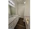 Bathroom featuring granite countertop vanity, soaking tub and wood-look flooring at 240 Carsons Cv, Mcdonough, GA 30253