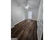 Bright bedroom with dark hardwood floors, white walls, ceiling fan and window at 240 Carsons Cv, Mcdonough, GA 30253