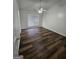 Spacious bedroom with dark wood-look flooring, ceiling fan and natural light at 240 Carsons Cv, Mcdonough, GA 30253